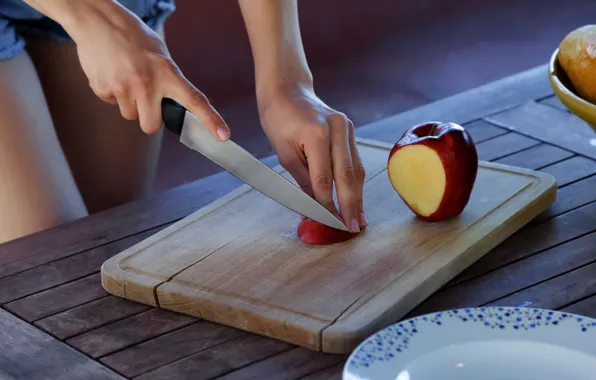 Picture Apple, hands, knife, cutting board, wood table, slicing fruit