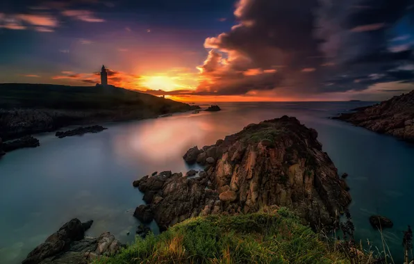 Picture sea, clouds, sunset, stones, rocks, shore, lighthouse, bright colors
