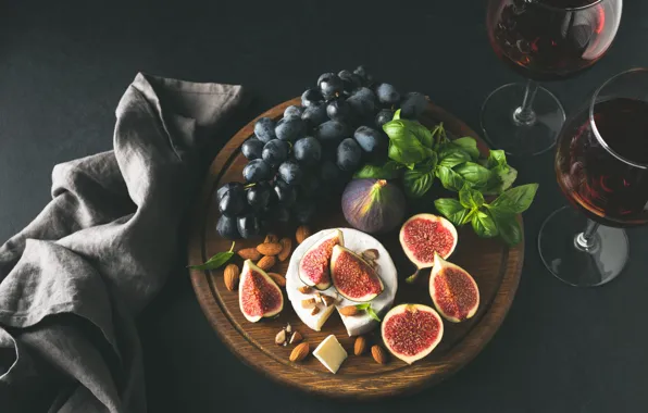 Picture the dark background, table, wine, towel, cheese, glasses, grapes, fruit, nuts, slices, almonds, tray, figs, …