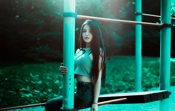 Picture grass, trees, jeans, Woman, sitting, outdoors, poles, teal crop top
